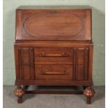 An oak linen fold style bureau with large bar pull handles