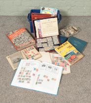 A large collection of stamps from Great Britain in several albums with a small container of