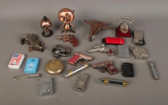 A good collection of lighters, mainly novelty examples, to include skulls, fighter jet, crocodile,