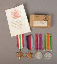 A set of four WWII medals with ribbons in original box. Awarded to J.S Blenkin, ESQ. Includes 1939-