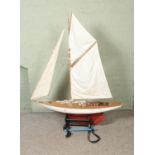 A very large remote control model pond yacht titled Moonbeam on display stand modelled after an