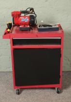 A red and black tool cabinet on casters with contents of assorted tools to include Clarke Wiz Air