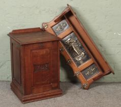 An oak coal box with carved panel front with "1743" carved to front together with an oak and brass