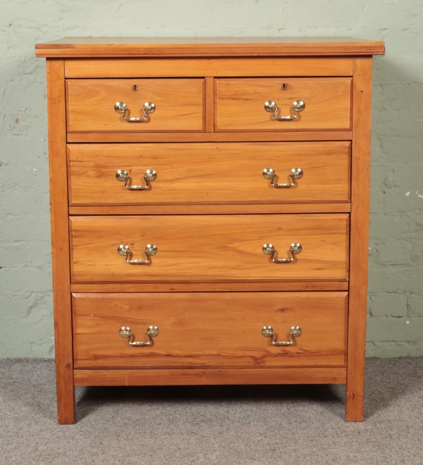 A Victorian walnut chest of two over three drawers, with later brass handles. Height: 107cm,