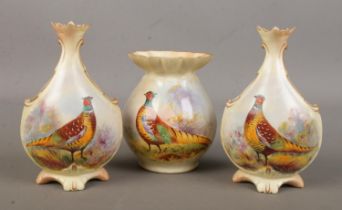 A pair of Locke & Co Worcester vases along with one other. All hand painted and decorated with a
