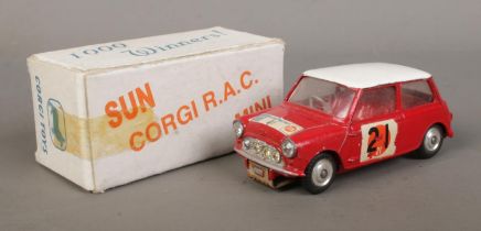 A Corgi BMC Mini Cooper S, from '1000 Winners', in red with contrasting white roof. In white
