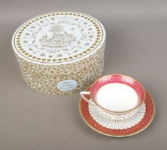 A boxed Wedgwood tea cup and saucer in the Queen of Hearts pattern.