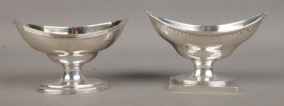A near pair of large Georgian silver salts, with elliptical bowls, both on stepped oval base; one