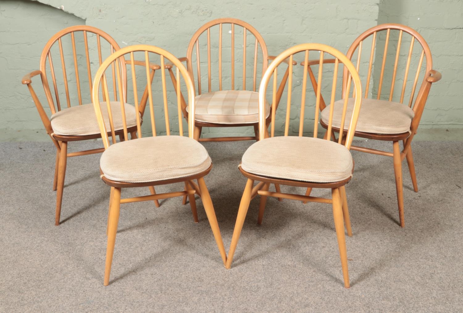 A harlequin set of five dining chairs, to include three Ercol Windsor elbow examples; model 370, for