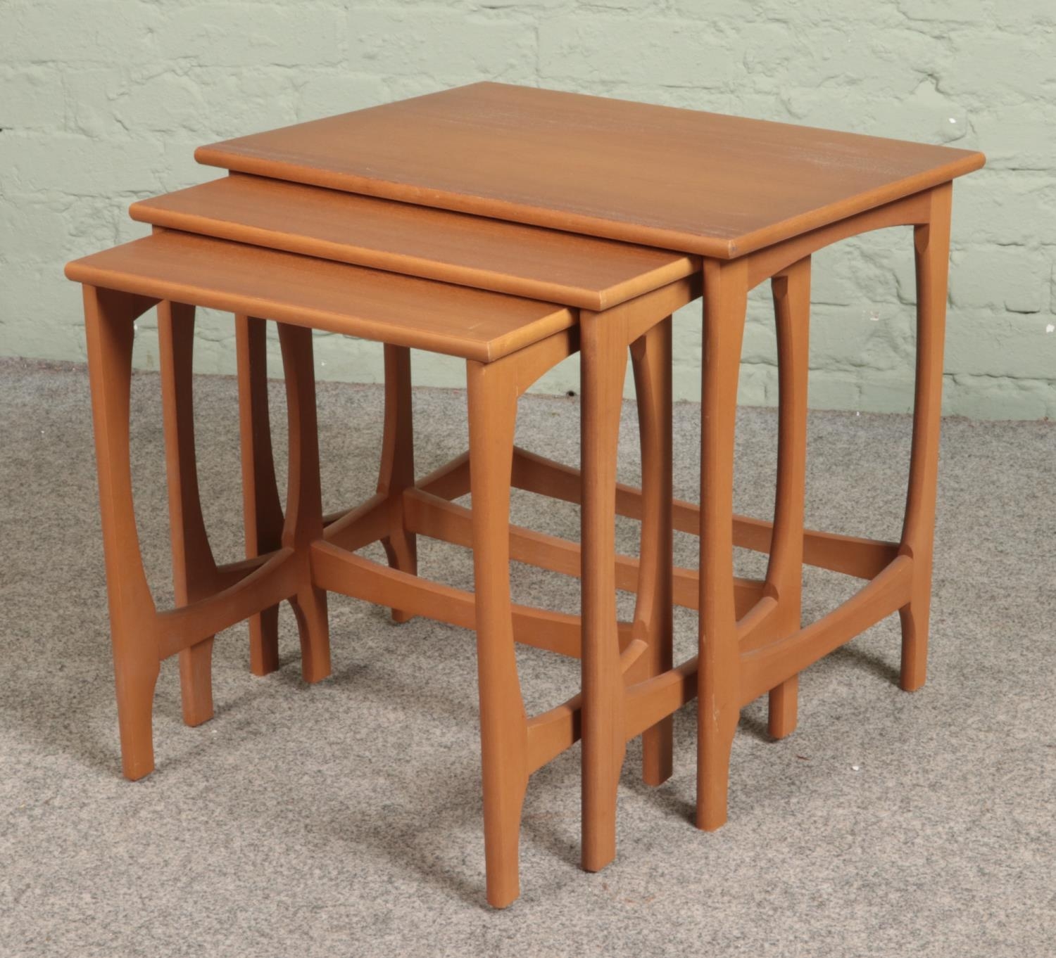 A teak nest of three tables.