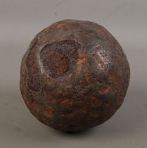 A large antique iron cannon ball. Diameter approximately 15cm.