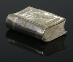 A George III silver snuff box in the shape of a book. The front cover engraved after James