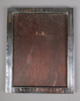 A silver mounted picture frame 24cmx19cm Hallmarks faded and indistinct.