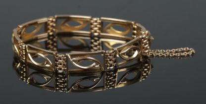 A 15ct gold open panel bracelet. 17.31g.