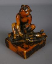 A decorative seal stamp formed as a seated monkey featuring character marks to base. Approx.