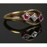 An 18ct gold and platinum, diamond and ruby three stone ring. Makers mark for AW Crosbee & Sons Ltd.