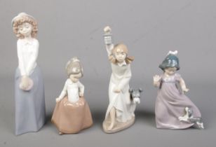 Four Nao by Lladro ceramic figures each depicting young girls, two with dogs.