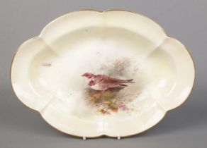 James Stinton for Royal Worcester, a porcelain lobed dish with hand painted scene depicting a Sand