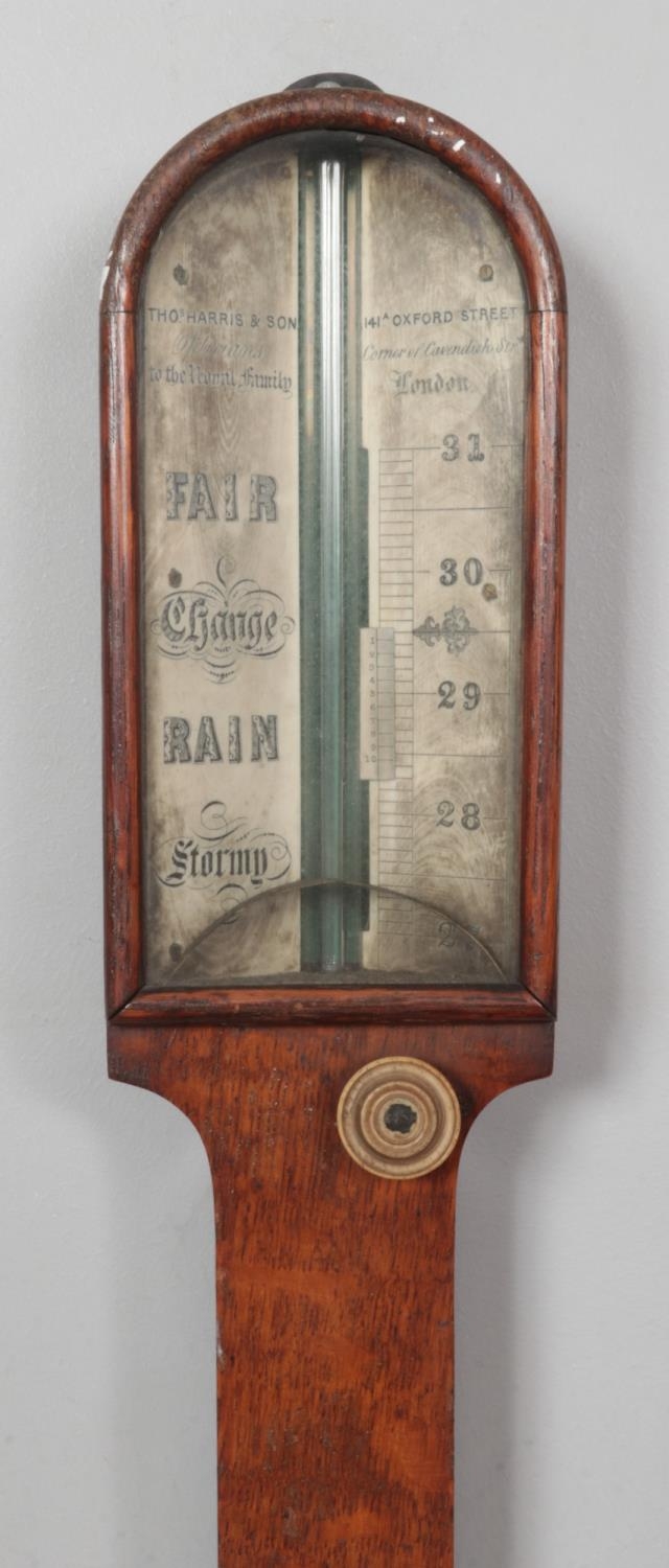 An early 19th century Thomas Harris & Son oak stick barometer. Length 92cm. - Image 2 of 2