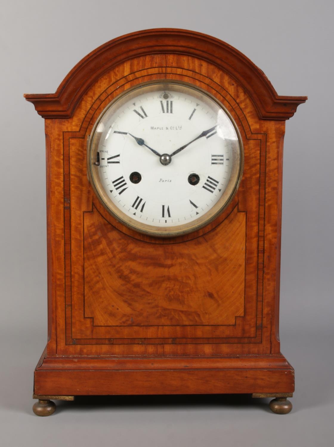 A Maple & Co Ltd. mahogany eight day bracket clock. Having enamel dial, Roman numeral markers and