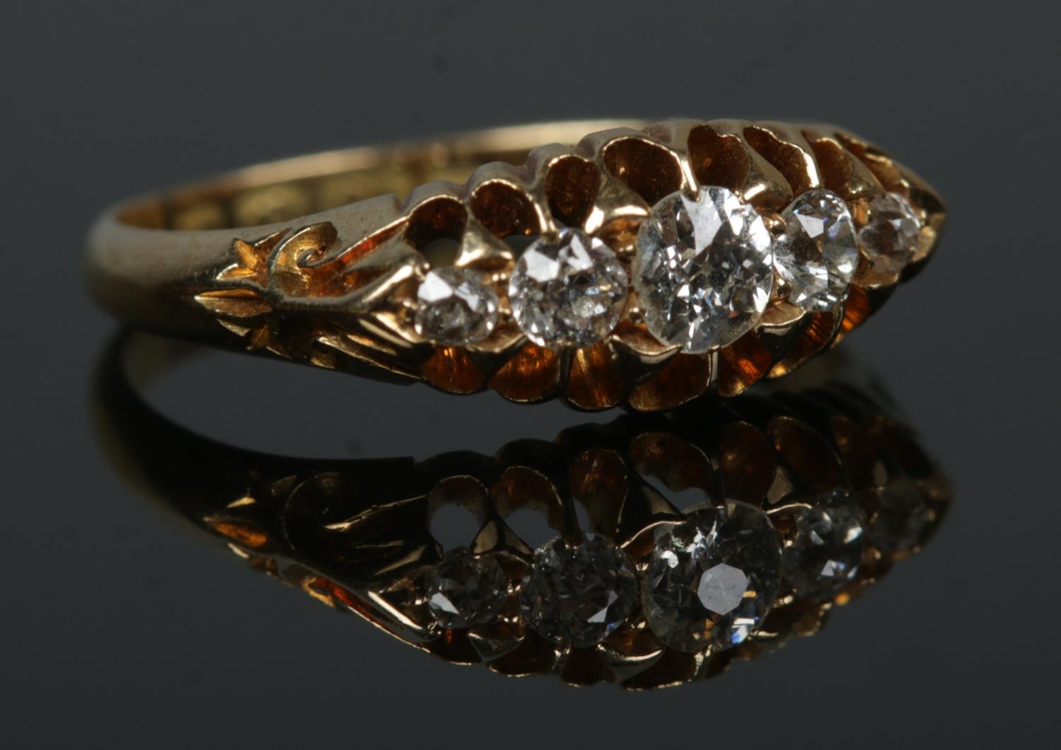 An early 20th century 18ct gold five stone diamond ring in claw setting. Size N. 3.51g.