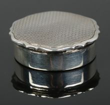 A silver pill box with engine turned engraving to lid. Assayed Birmingham 1933 by William Neale &