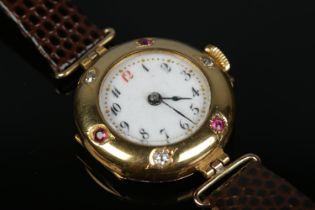 A ladies 18ct gold, diamond and ruby manual wristwatch on leather strap with 9ct gold buckle.