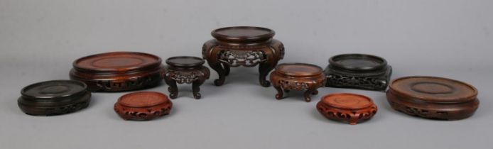 Nine Chinese carved hardwood stands of various sizes. Largest 15.5cm, Smallest 6cm.