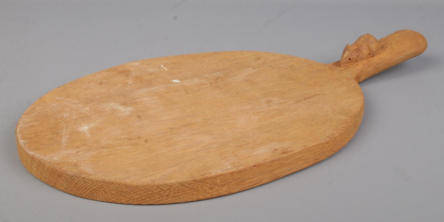 Robert 'Mouseman' Thompson, an oak cheese board with handle and signature mouse carving. Length 39.