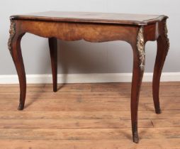 An antique French walnut side table with strung inlay and ormolu mounts.