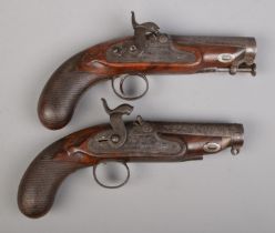 A pair of 19th century percussion pistols. The lock plates marked for IM Burnie. Total length