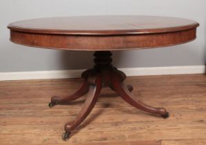 A large Victorian mahogany pedestal dining table. Diameter of top 140cm.