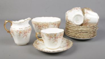 An Aynsley part tea set No.291231 including five teacups, nine saucers, jug and bowl.