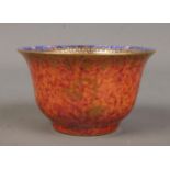 A Wedgwood Lustre miniature bowl by Daisy Makeig Jones, decorated with motifs. Having mottled orange