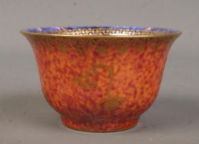 A Wedgwood Lustre miniature bowl by Daisy Makeig Jones, decorated with motifs. Having mottled orange
