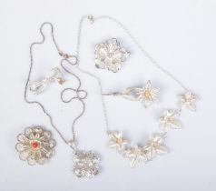 A small collection of silver filigree jewellery to include two necklaces on silver chains and four