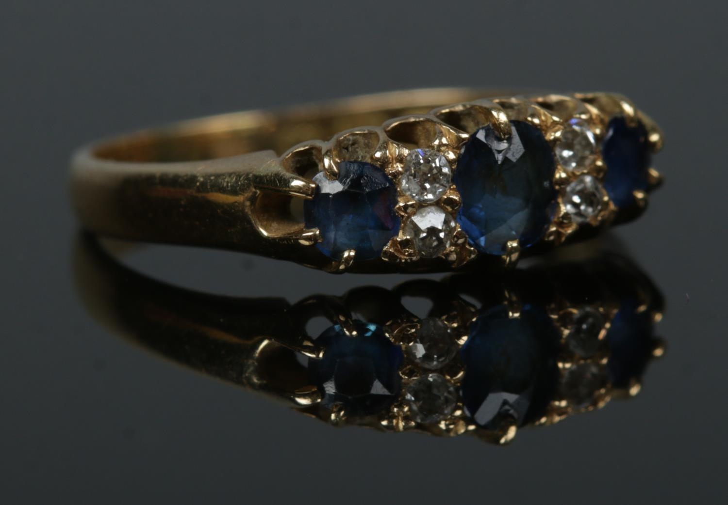 An 18ct gold sapphire and diamond ring. Size O. 2.94g.