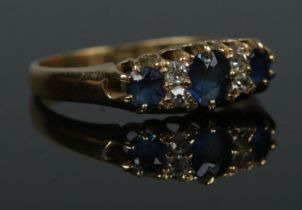 An 18ct gold sapphire and diamond ring. Size O. 2.94g.