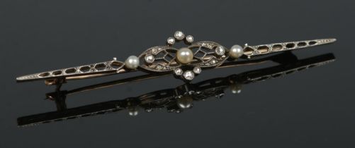 A gold diamond and seed pearl bar brooch. Tested. Length 7cm. 3.24g.