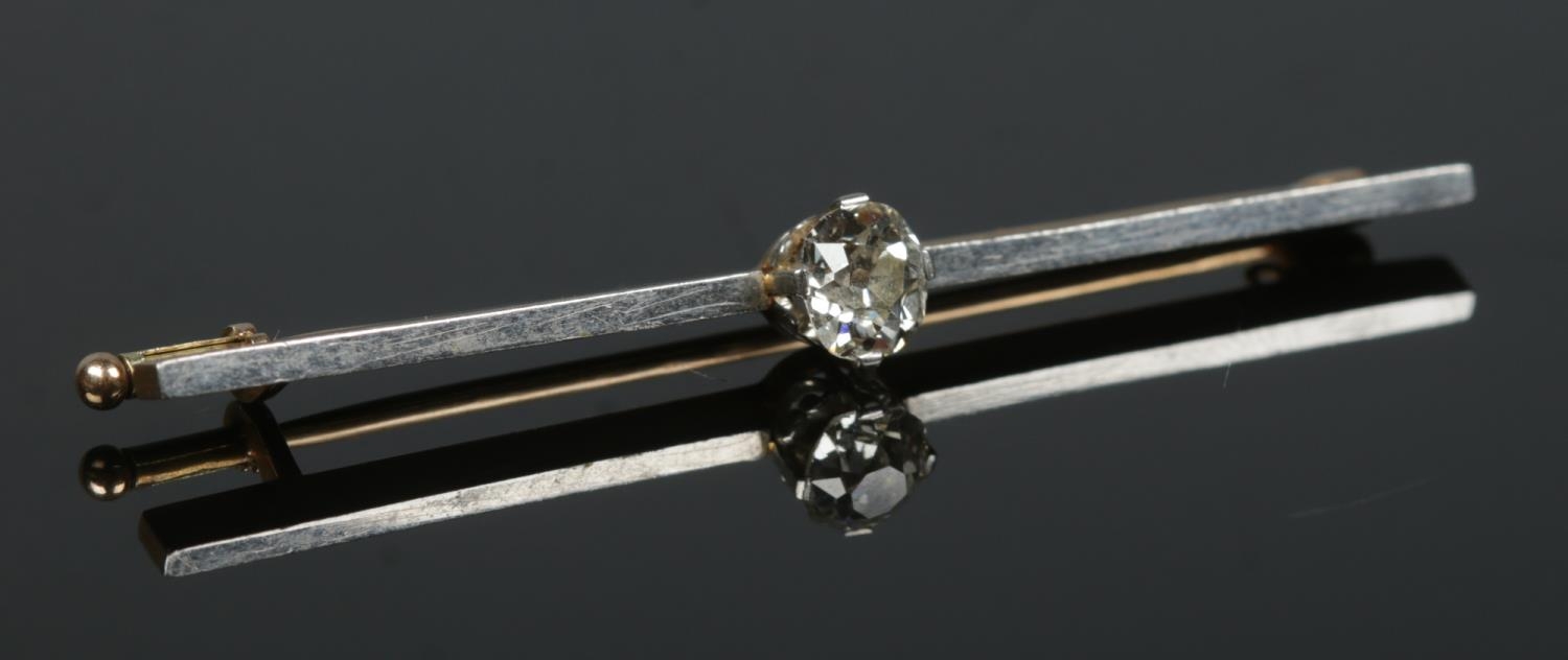 A gold and platinum bar brooch set with a single diamond (approximately 0.75ct - 6mm x 5mm). Tested.
