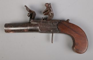 A 19th century flint lock pistol with cylindrical barrel and pull down trigger. Makers mark for W
