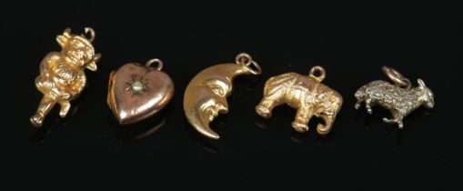 Two 9ct gold charm pendants along with three unmarked examples. 9ct gold examples; crescent moon and