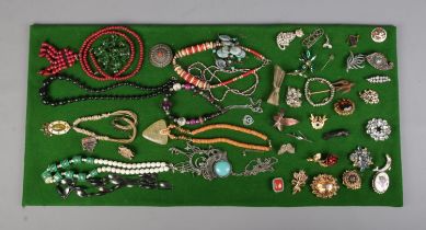 A collection of assorted costume jewellery of mostly beaded necklaces and brooches to include one