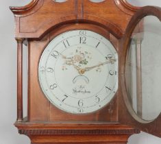 A Georgian oak longcase clock. Having twin swan neck pediment and painted enamel dial marked for Mos