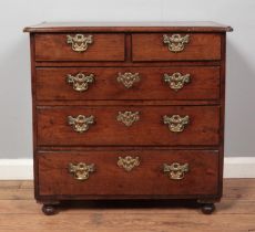 A Georgian oak bachelors chest of two over three drawers. Height 73cm, Width 77cm, Depth 46cm.