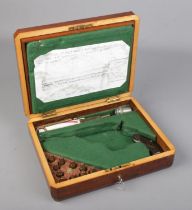 An oak pistol box fashioned for a Smith & Wesson double action revolver. With grip, inert rounds and