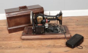 An oak cased Jones sewing machine converted to electric with Hillman motor.