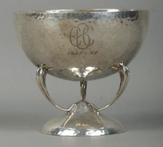 An Arts & Crafts silver bowl, raised on three curvilinear supports on circular base. Monogramed to