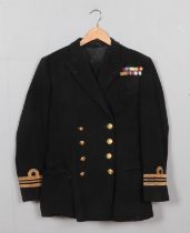 A British Royal Navy Lieutenant Commander's uniform jacket and trousers. Paperwork belonging to