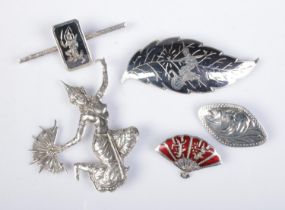Five silver brooches to include several marked for Siam on reverse and depicting a goddess.